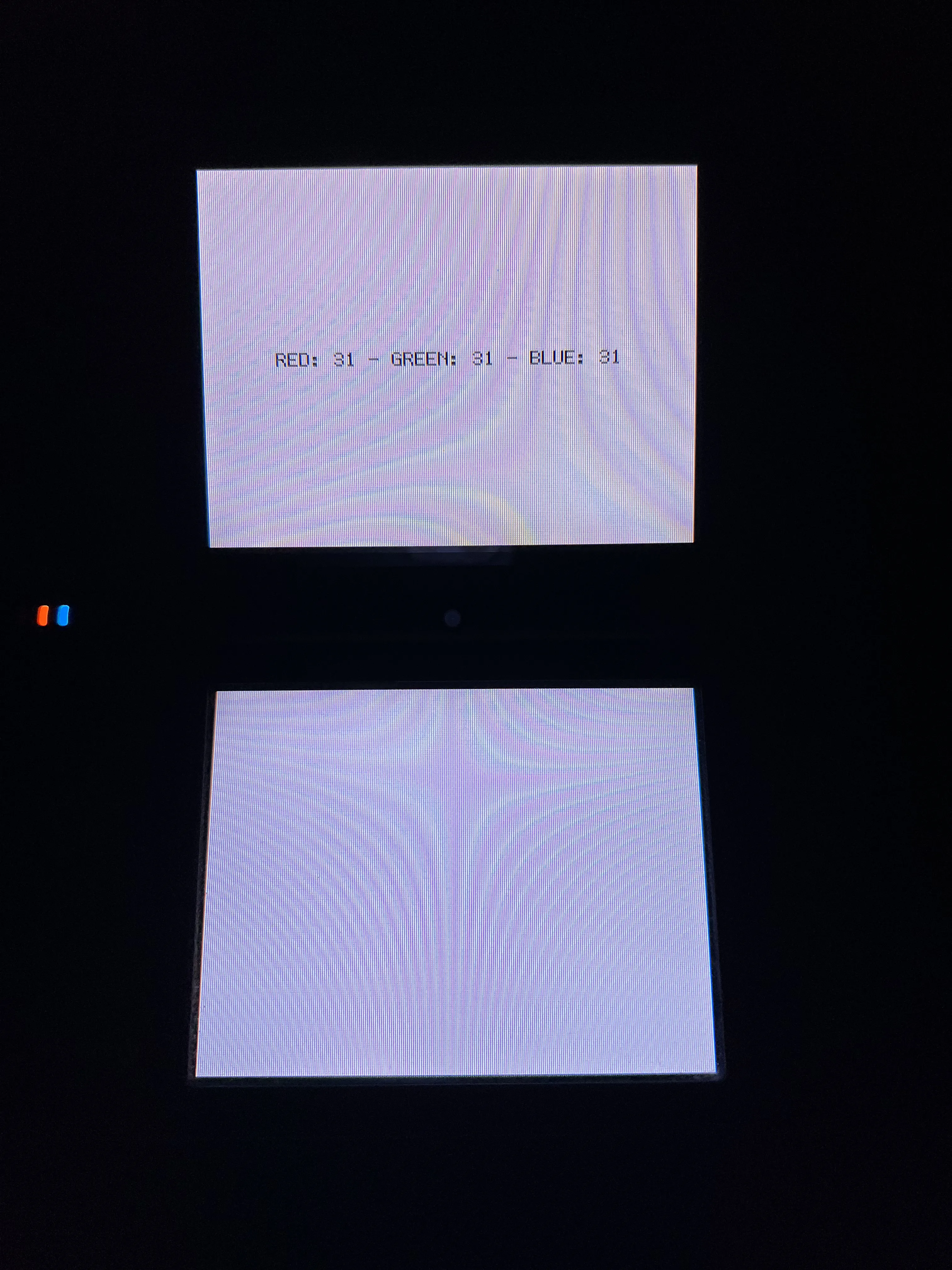 The Nintendo DSi XL after 100 days of displaying a pure white image. The rainbow effect is only visible on camera.